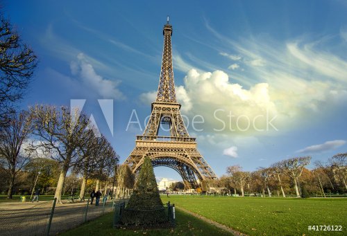 Curves of the Eiffel Tower under blue sky at shiny Winter mornin