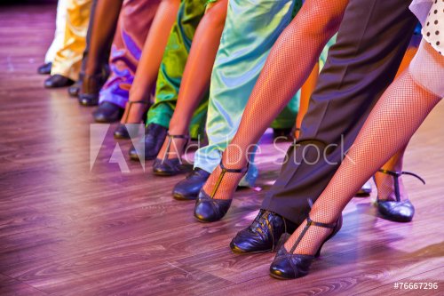 dancer legs on stage in dance position, male female colorful
