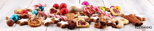 Decoration with christmas cookies. Typical cinnamon stars with fruits and nuts - 901152503