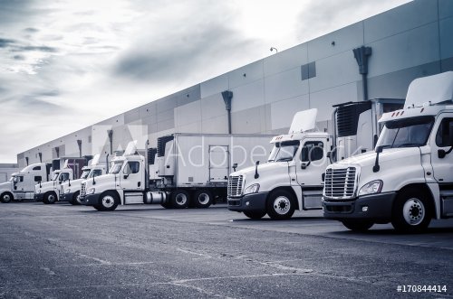 Delivering or Supply concept image.  Trucks loading at facility. - 901152621