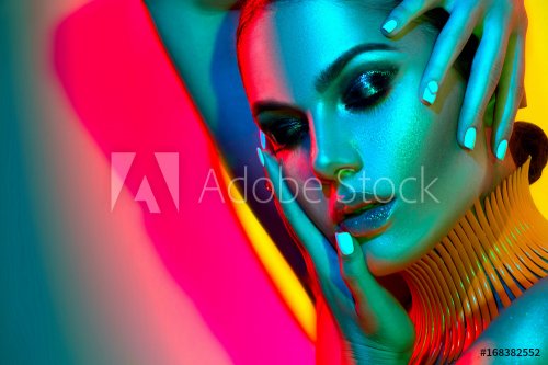 Fashion model woman in colorful bright lights with trendy makeup and manicure... - 901149767