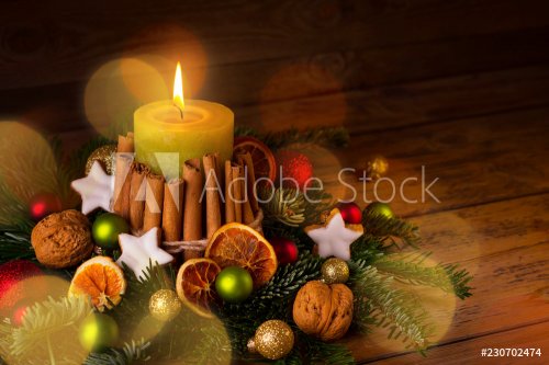 Festive Christmas arrangement with burning candle and natural decoration on r... - 901152572