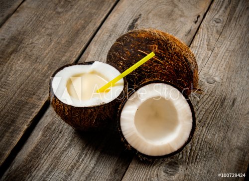 Fresh cocktail in coconut Cup on wooden background.