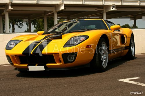 front of yellow supercar with black stripes - 901144542