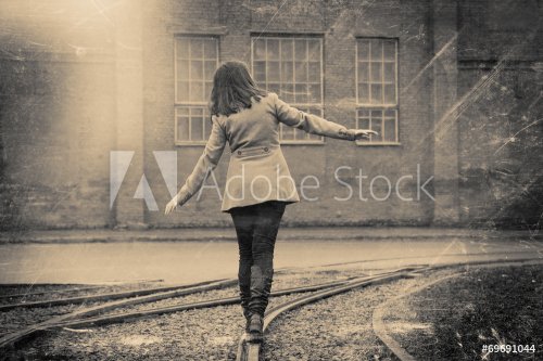 girl walking on the railway, retro stylized photo - 901153388