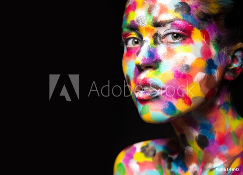 Girl with colored face painted. Art beauty image.  - 901153339
