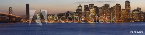 Golden sunset sky behind Bay Bridge and San Francisco - 900452560