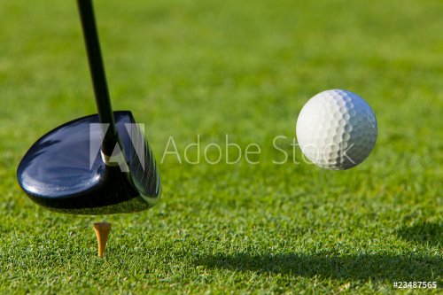 Golf ball hit off the tee with driver on golf course - 900167693
