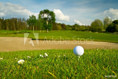 Golf ball on the beautiful golf course with sandbanks