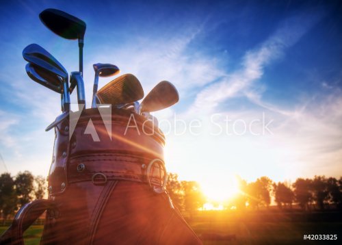 Golf gear, clubs at sunset on golf course - 901139419