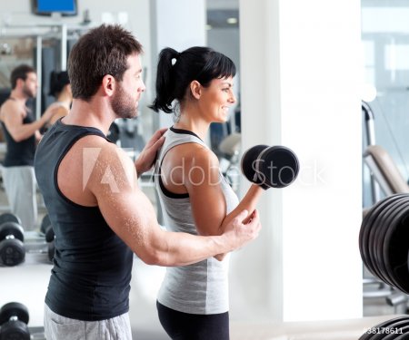 gym woman personal trainer with weight training - 900286386