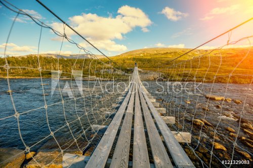 hanging bridge over mountain river - 901147962