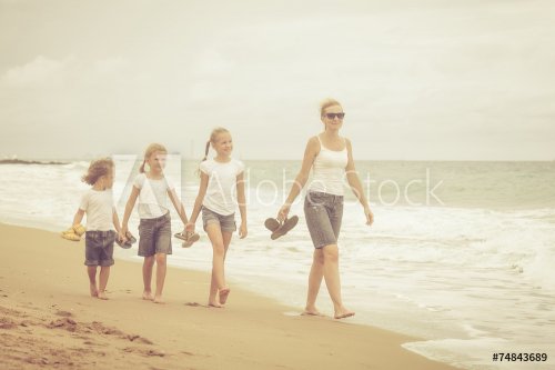 Happy family playing on the beach at the day time. - 901144126