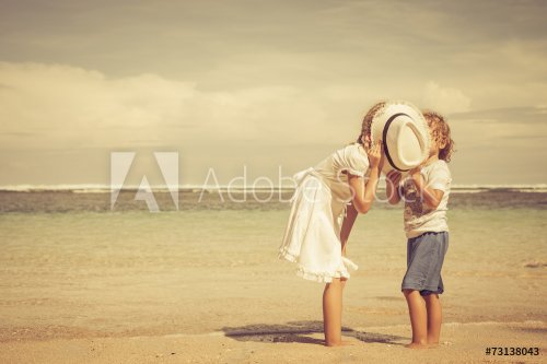 happy kids playing on beach at the day time - 901144127