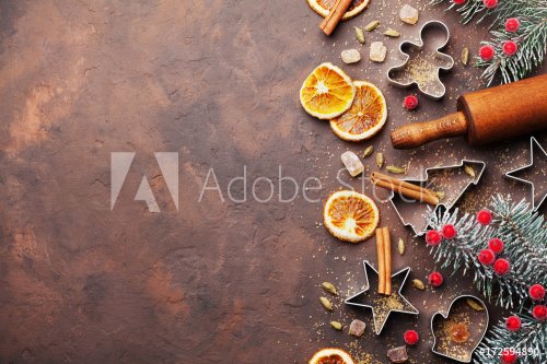Holiday christmas background for baking cookies with cutters, rolling pin and spices on brown table top view. Copy space for text.