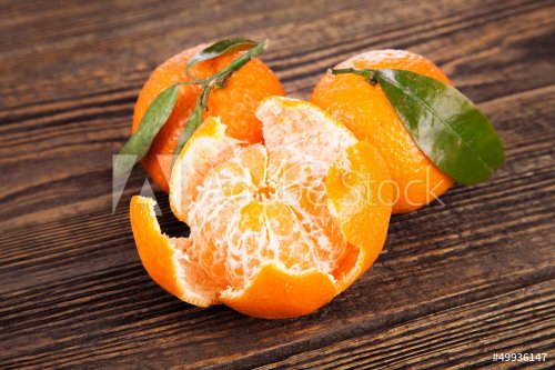 Juicy tangerines on a wooden table