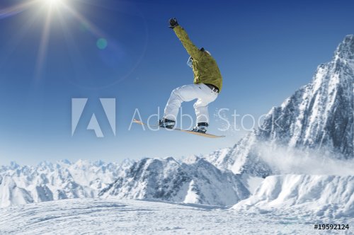 Jumping Snowboarder in alpine mountains