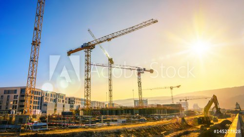 Large construction site including several cranes working on a building comple... - 901152747