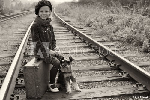 Little girl traveling with her dog. The old European photo.