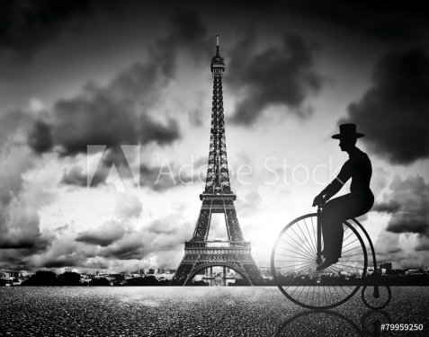 Man on retro bicycle next to Effel Tower, Paris, France.