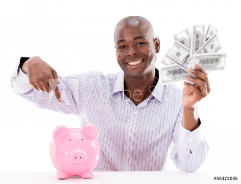 Man saving money in a piggybank - 901139673