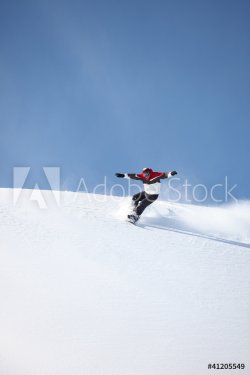 Man snowboarding down hill - 900454068