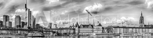 Monochrome black and white wide vintage style panorama of Frankfurt / Main, Germany, Europe with river Main, skyscrapers, cathedral and cranes