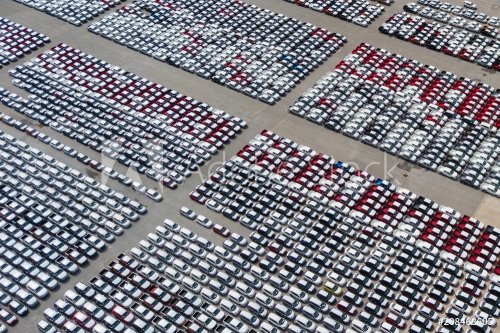 New cars from the car factory parked at the port waiting for export to the country as orderedNew cars from the car factory parked at the port waiting for export to the country as ordered