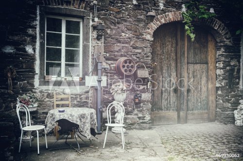 Old farm backyard with table and chairs