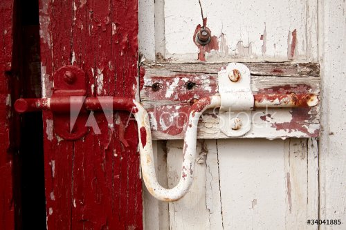 Old painted lock on the barn doors.