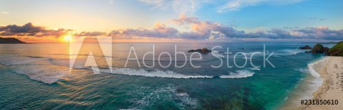 Panoramic view of tropical beach with surfers at sunset. - 901152309