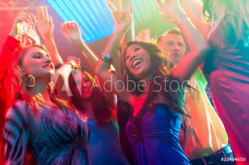 Party people dancing in disco or club - 900440540