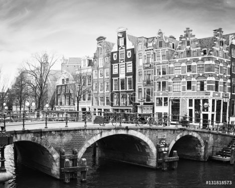 Prinsengracht Canal, Amsterdam, The Netherlands. Typical  Dutch houses  with a crow-stepped gable  behind the bridge.  Black and white. 