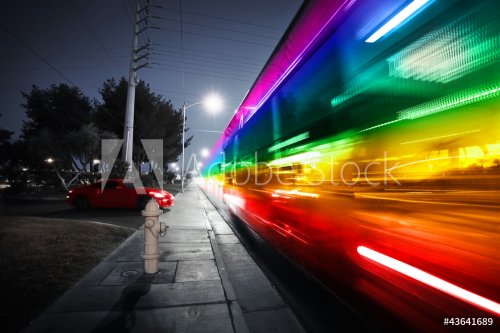 Rainbow spectrum blurred motion city bus at night - 900692699