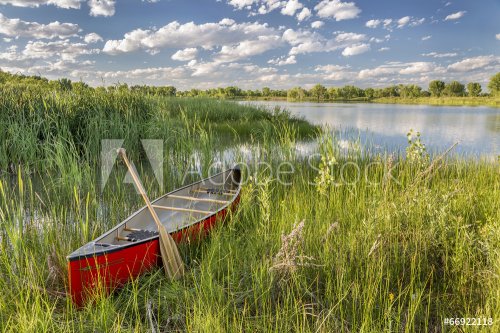 red canoe on lake shore - 901147858
