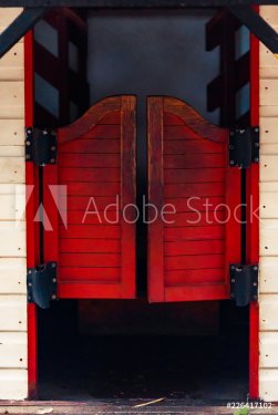 Red closed Western Saloon doors on a white wooden wall on a bright sunny day - 901154296
