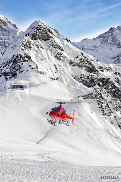 Red helicopter landing at swiss ski resort near Tschuggen peak - 901145615