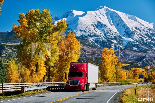 Red truck on highway in Colorado at autumn - 901154271