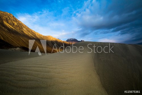 sand dunes against the background of distant colorful mountain r - 901147577
