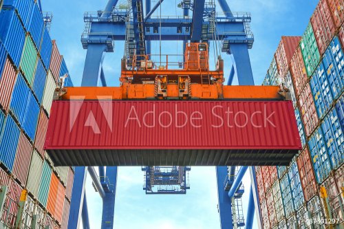 Shore crane loading containers in freight ship - 901152666