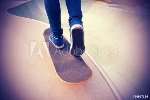 skateboarding woman legs at skatepark  - 901144470