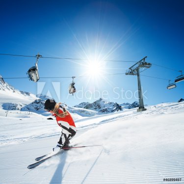 Skier in mountains, prepared piste and sunny day - 900905765