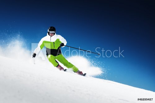 Skier in mountains, prepared piste and sunny day - 900905785