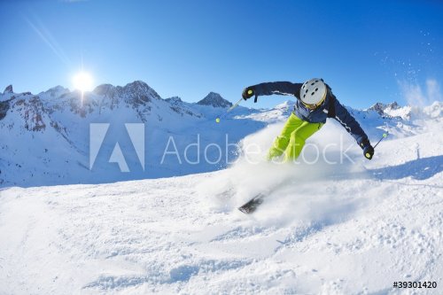 skiing on fresh snow at winter season at beautiful sunny day - 900454173
