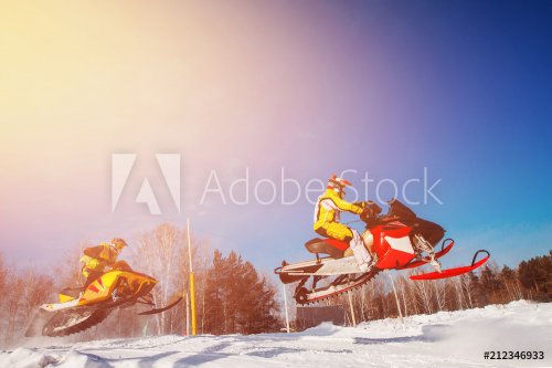 Snowmobile races jump in snow dust. Concept winter extreme sports