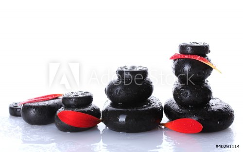 Spa stones with drops and petals isolated on white