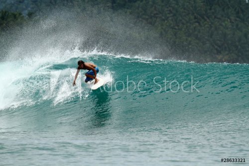 Speed surfer on tropical green wave