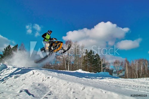 Sport yellow snowmobile jump. Sunny winter day with blue sky. Concept quick m... - 901151609