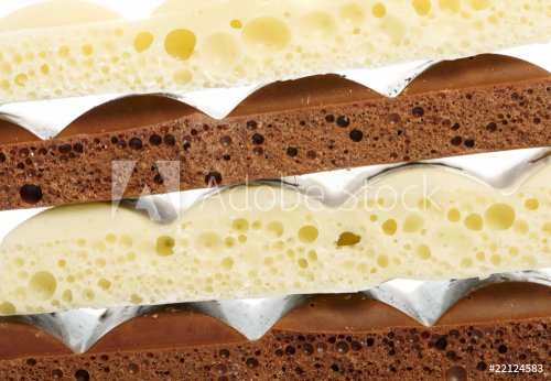 Stack of brown and white porous chocolate - 900673755