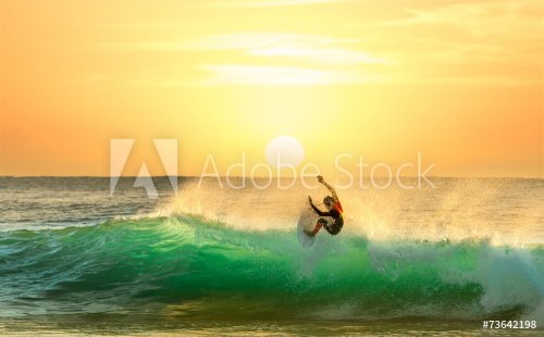 Surfer Surfing at Sunrise - 901148780